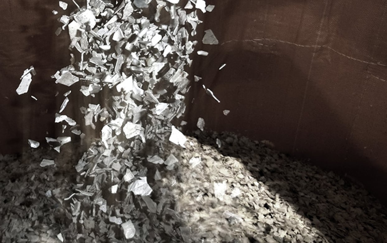 Recycling shredded plastics.