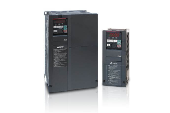 Two Mitsubishi variable frequency drives (VFDs) in gray, one larger and one smaller, with control panels and digital displays.